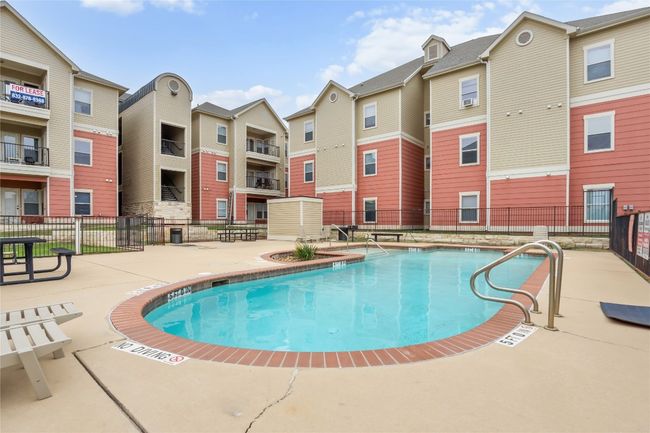Community pool featuring a patio area, fence, and a residential view | Image 27