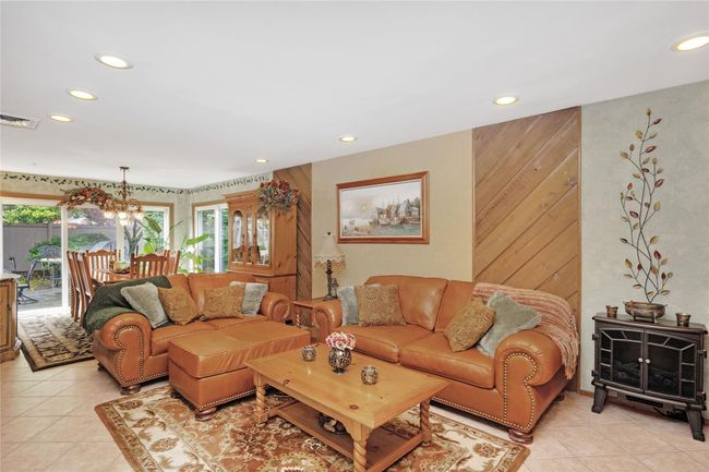 Dining room with a chandelier, plenty of natural light, light tile patterned flooring, and recessed lighting | Image 15