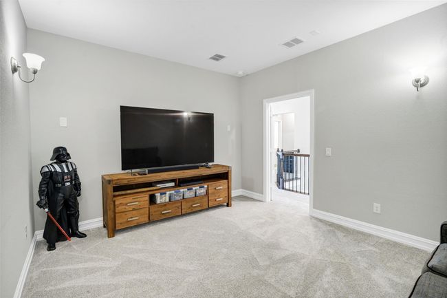 Media room features french doors, carpet and wall lighting. | Image 30