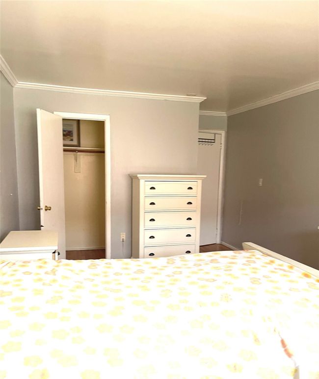 Unfurnished bedroom with a closet and crown molding | Image 4