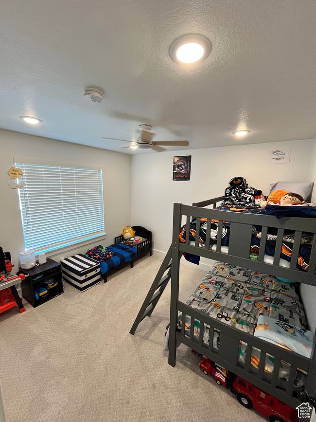 Bedroom featuring carpet flooring, a ceiling fan, and a textured ceiling | Image 26