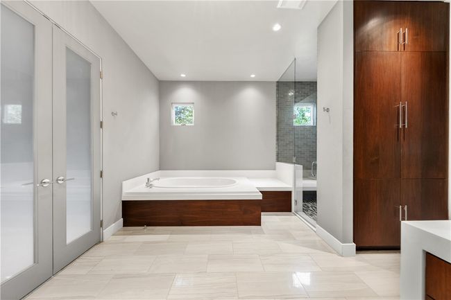 Bathroom with healthy amount of natural light, a bath, a stall shower, vanity, and recessed lighting | Image 24