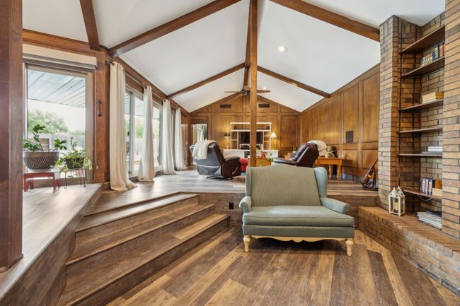 Stunning Wood Paneling and a Wall of Window Frame the Multi-level Living Space | Image 8