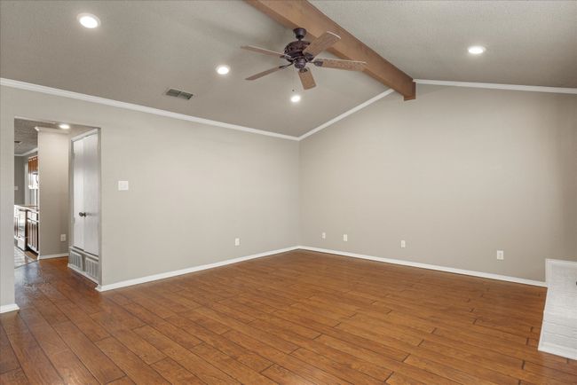 Front entry to light bright living area with vaulted, beamed ceiling. | Image 9