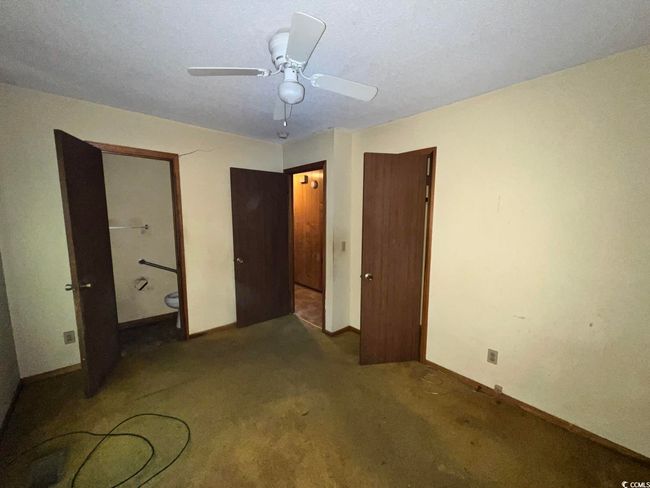 Unfurnished bedroom featuring carpet, baseboards, and a ceiling fan | Image 15