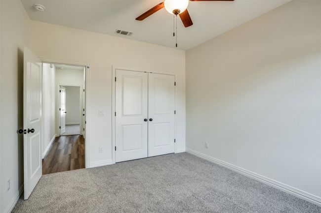 Unfurnished bedroom featuring baseboards, carpet flooring, visible vents, and a closet | Image 21