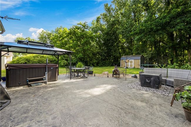 View of patio / terrace with a gazebo, outdoor lounge area, a hot tub, and a storage unit | Image 42