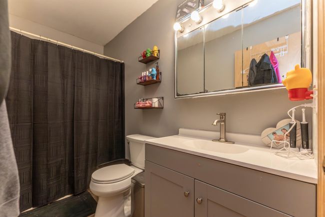 Full bath featuring toilet, vanity, and a shower with curtain | Image 37