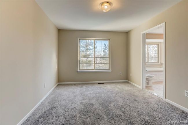 Bedroom 2 with new carpeting and shared Jack and Jill bath access. | Image 17