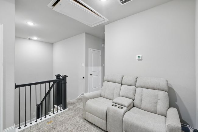 Carpeted living room featuring attic access and recessed lighting | Image 10