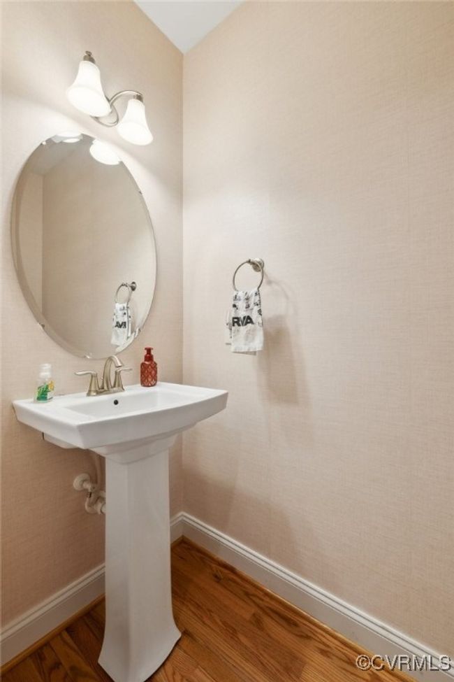 1st floor powder room with hardwood flooring and pedestal sink (toilet not pictured). | Image 32