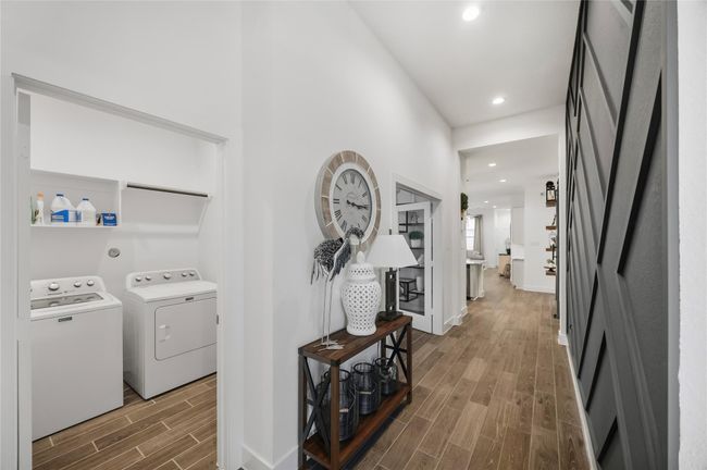 The central hallway creates a seamless transition through the home, accented by high ceilings and crisp designer finishes that make every step feel sophisticated. | Image 4