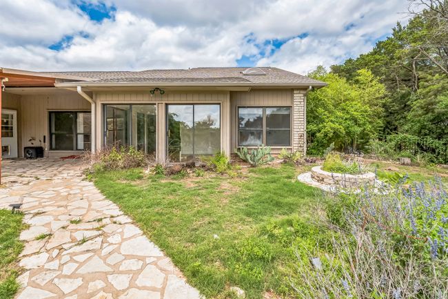 Rear view of house featuring roof with shingles and a lawn | Image 40