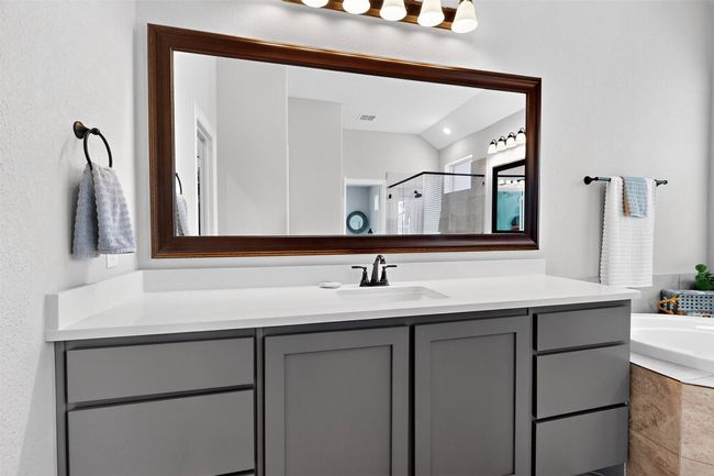 Full bath with vanity, a shower stall, a bath, and vaulted ceiling | Image 16