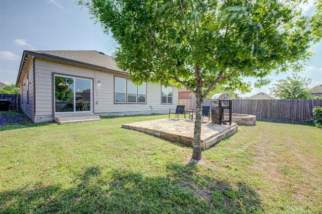 Back of property with a fenced backyard, a yard, and a patio area | Image 21
