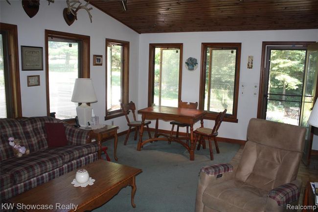 Sunroom, again with lots of natural light. Also as a door that opens out onto the fire pit area. | Image 14