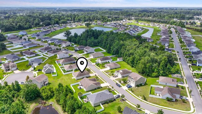 Aerial view of property and surrounding area featuring a nearby body of water and nearby suburban area | Image 25