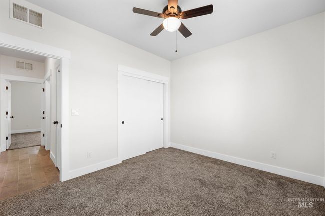 Unfurnished bedroom with carpet, a closet, and a ceiling fan | Image 30