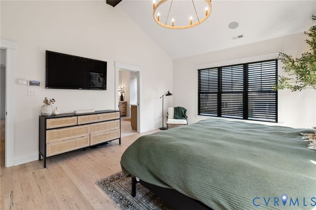Bedroom with a chandelier, light wood-style flooring, high vaulted ceiling, and beamed ceiling | Image 34