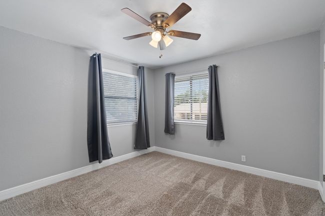 Unfurnished room with ceiling fan and carpet | Image 24