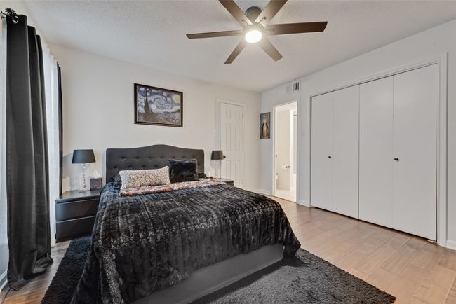Bedroom with wood finished floors and a ceiling fan | Image 13