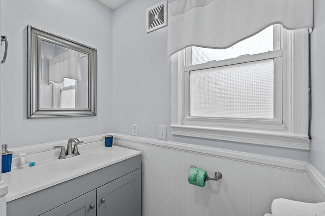 Bathroom with a wainscoted wall and vanity | Image 11