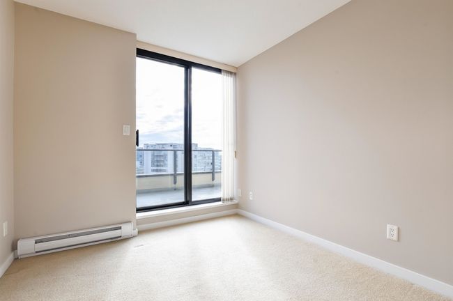 Unfurnished room featuring a baseboard radiator and carpet | Image 24