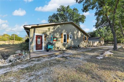 View of front of house featuring a wooden deck | Image 1