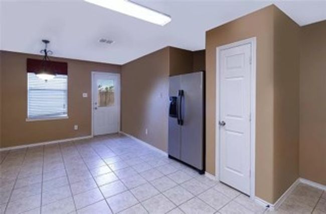 Empty room with baseboards and light tile patterned flooring | Image 6