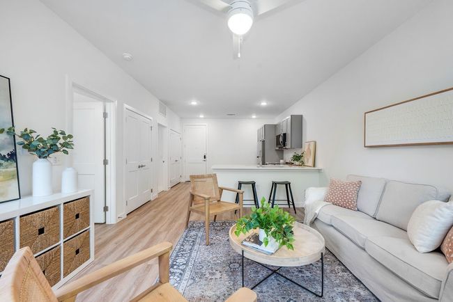 Living room with light wood-style flooring, recessed lighting, and a ceiling fan | Image 5