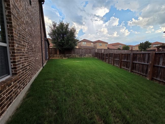 View of fenced backyard | Image 18