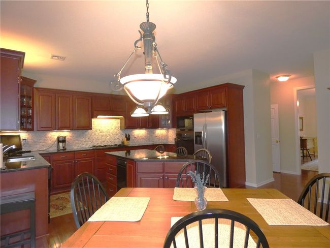 Special features in the fully equipped kitchen are stainless appliances, custom backsplash, granite countertops and maple cabinets | Image 19