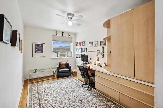 Office featuring ceiling fan, built in study area, wood finished floors, cooling unit, and baseboards | Image 18