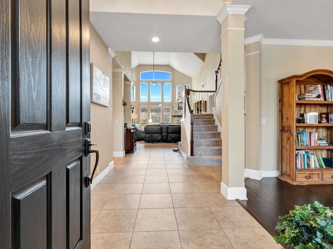 Foyer entrance, stairs, crown molding, and ornate columns | Image 7