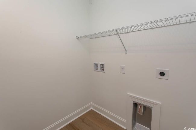 Washroom featuring hookup for an electric dryer, hookup for a washing machine, baseboards, and dark wood-type flooring | Image 17