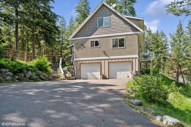 View of home's exterior with a garage and asphalt driveway | Image 52