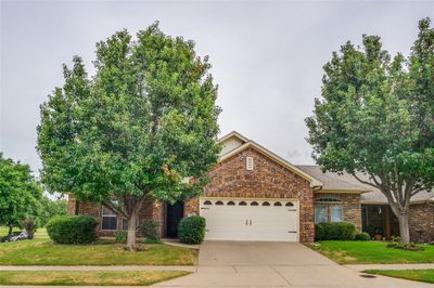 View of front of property featuring a garage and a front lawn | Image 1