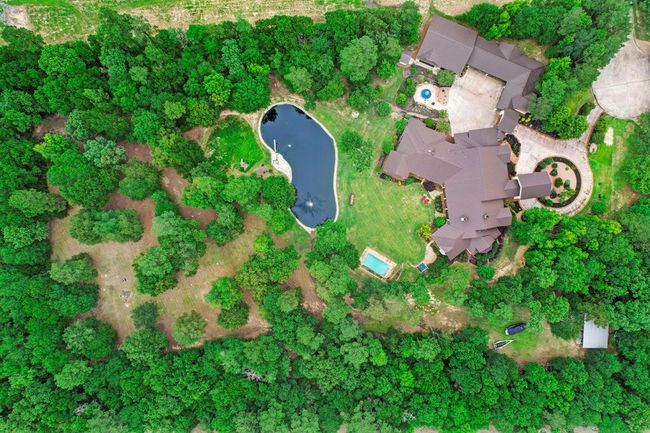 The lot includes professional golf grass in the immediate backyard and additional wooded acreage. | Image 5