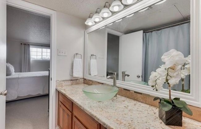 Ensuite bathroom featuring vanity and a textured ceiling | Image 20