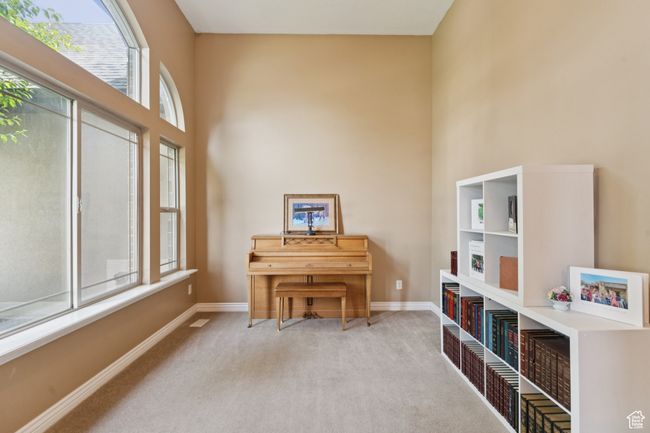 Sitting room with carpet, baseboards, and a towering ceiling | Image 5