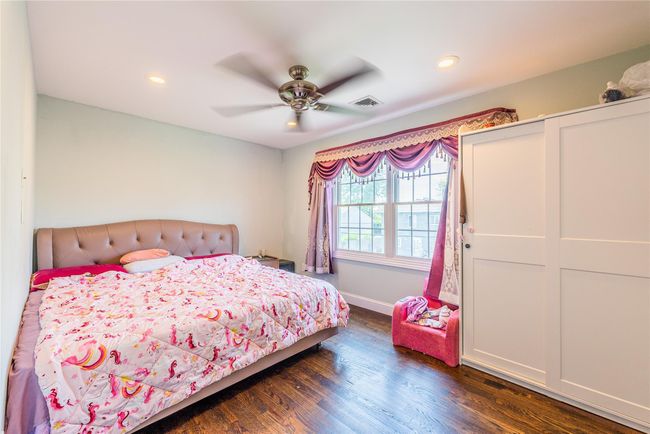 Bedroom featuring dark wood finished floors, recessed lighting, baseboards, and ceiling fan | Image 9