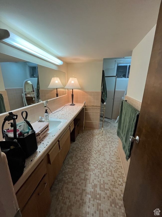 Bathroom featuring tile walls, wainscoting, and vanity | Image 25
