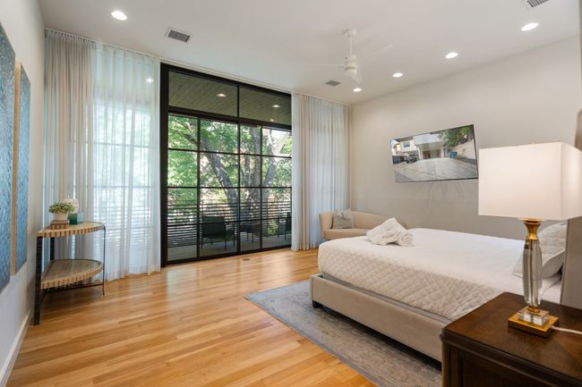 Bedroom with wood finished floors, expansive windows, access to outside, recessed lighting, and a ceiling fan | Image 15