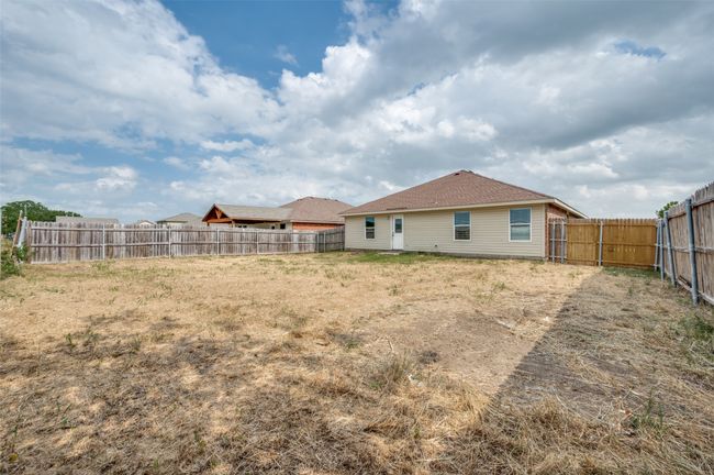 Back of house with a fenced backyard | Image 23