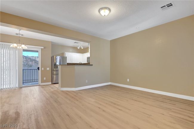 Unfurnished living room with baseboards, luxury viny plank flooring all throughout | Image 4