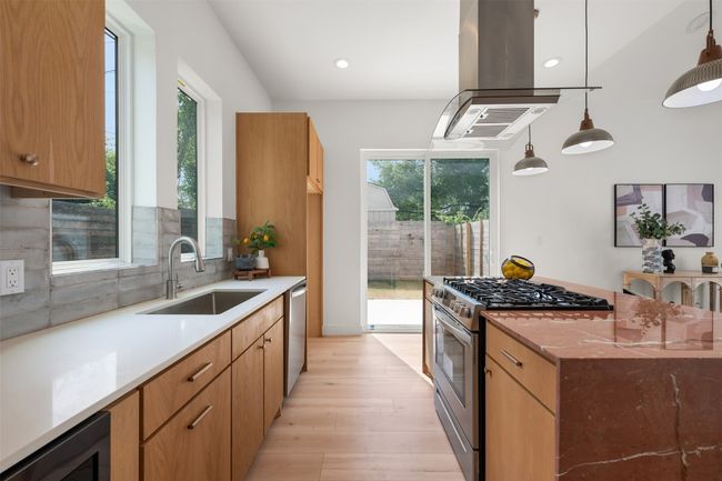 Kitchen with stainless steel appliances, a sink, wine cooler, healthy amount of natural light, and recessed lighting | Image 9
