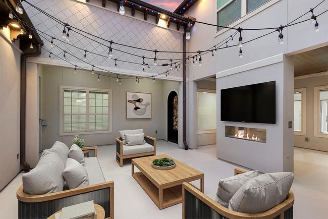 Courtyard invites intimate gatherings around the modern fireplace and under the soft gaze of open skies. *This photo has been virtually staged.* | Image 4