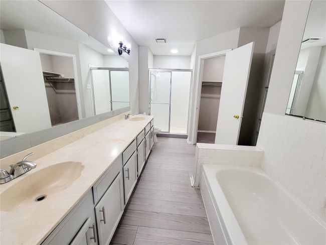 Bathroom featuring vanity, hardwood / wood-style floors, and plus walk in shower | Image 15