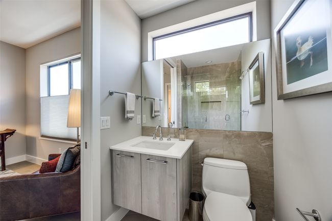 Bathroom with a shower stall, wood finished floors, toilet, vanity, and baseboards | Image 29