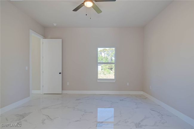 Unfurnished room with baseboards, marble finish floor, and ceiling fan | Image 12